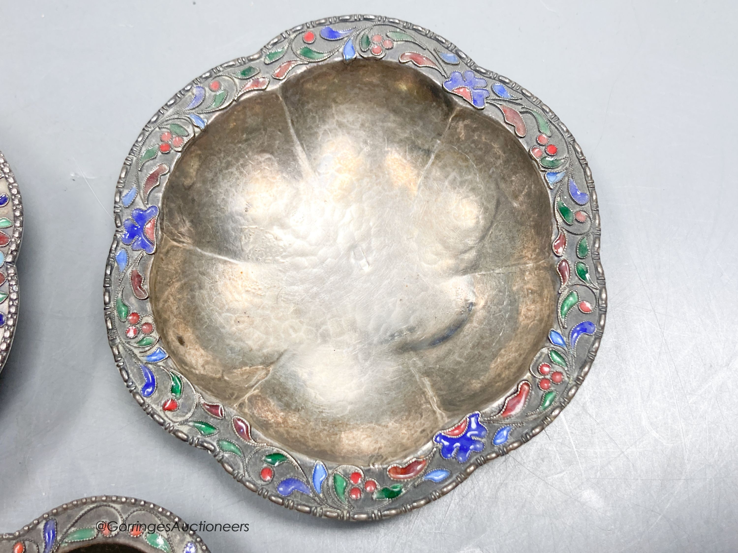 Three Persian white metal and cloisonne enamel small dishes, largest 9.6cm, gross weight 89 grams.